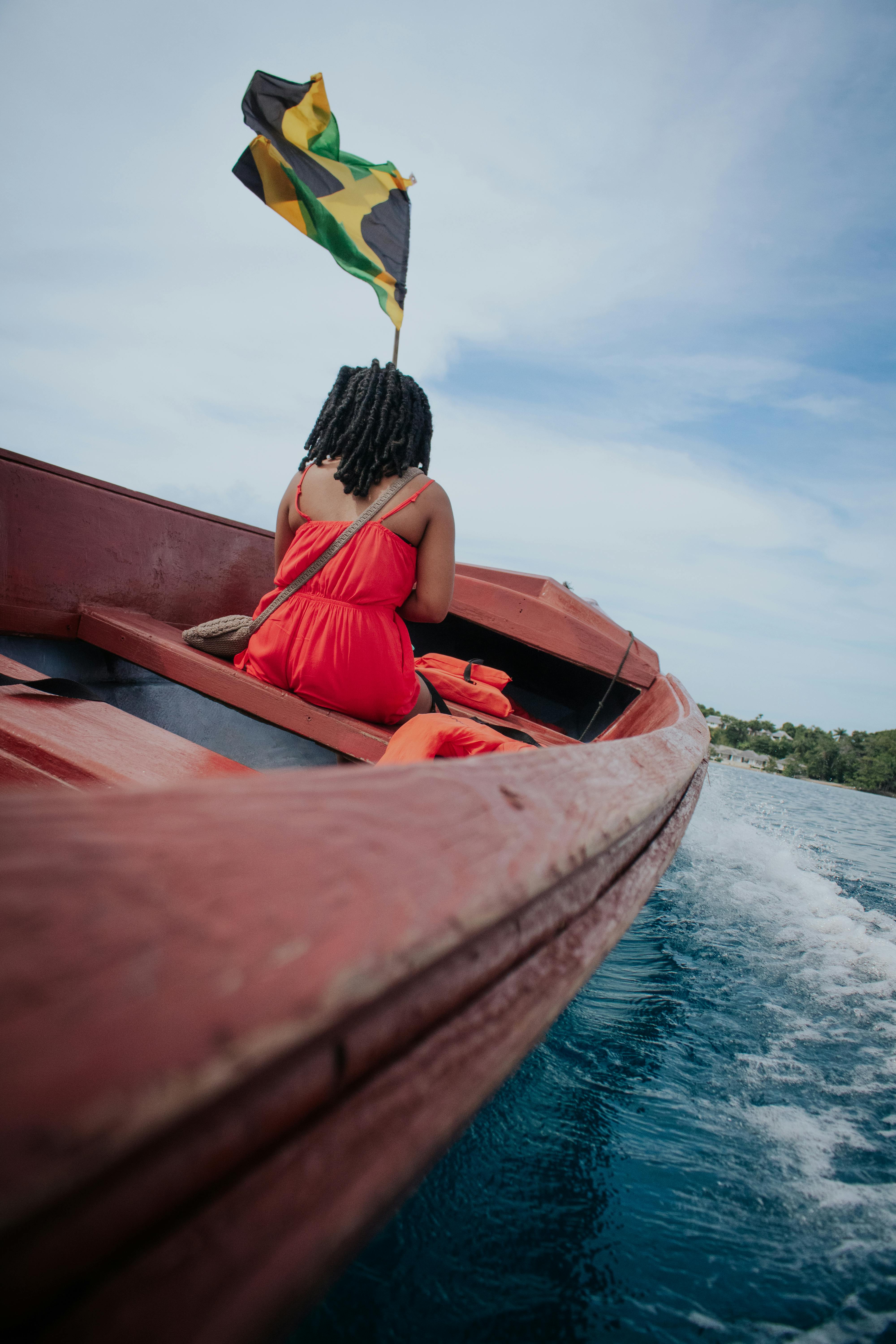 Little girl on a boat with a Jamaican flag.